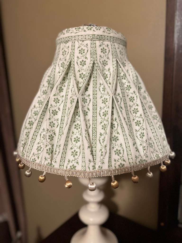 bespoke smocked lampshade in a mint vine linen with and silk embroidered gold and silver accent trim at the hem.